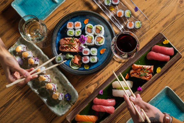 istock Anonymous couple eating various sushi with wine 1616721744