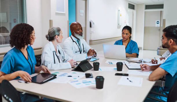 istock Doctors and nurses discussing work at staff meeting in conference room 1616721813