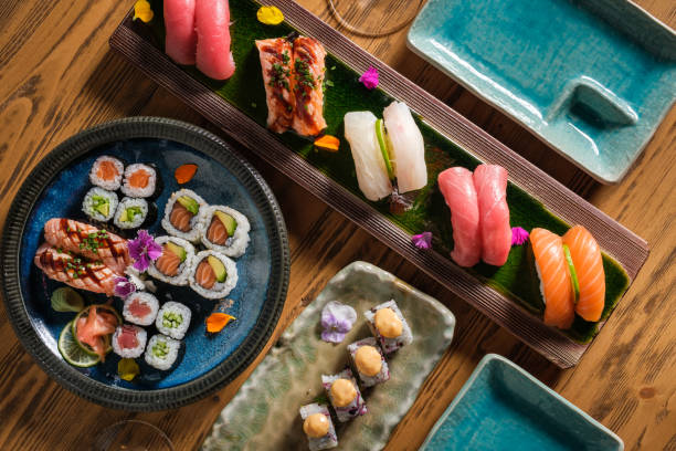 istock Assorted delicious sushi on wooden table 1616721845