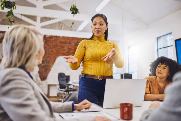 istock Low angle view of female executive introducing project manager at team meeting 1616721910