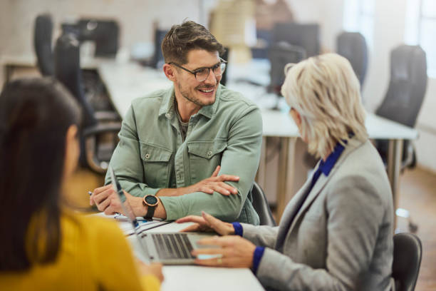 istock High angle view of executive smiling at Manager in team meeting 1616722081