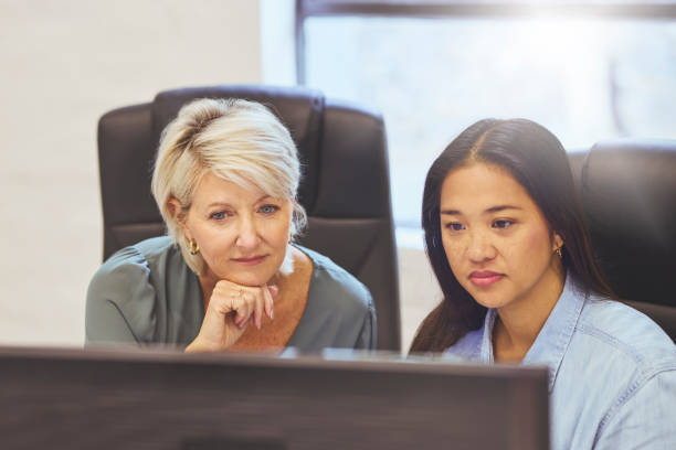 istock High angle view of manager and colleague using computer in office 1616722262