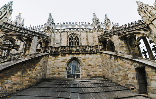 Flying buttress and ornately carved stonework on the roof of the Duomo Milano (Milan Cathedral), Italy