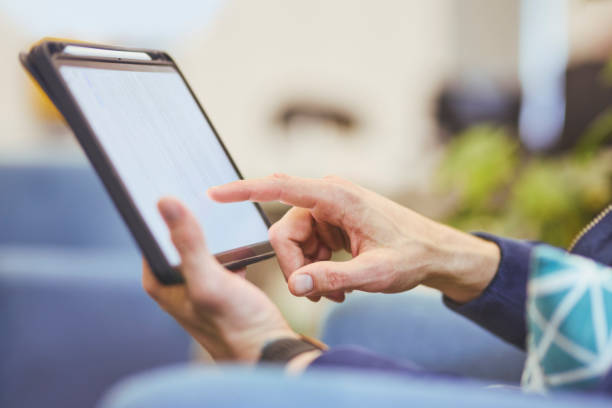 istock Close-up of man tapping on digital tablet 1616722320
