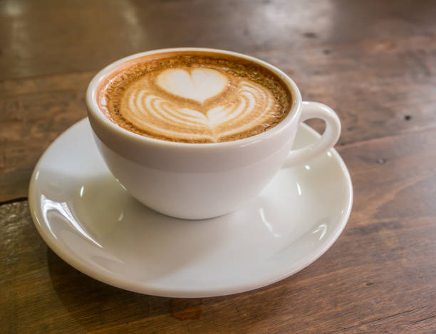 istock coffee with milk in a cup on wooden table 1616722541