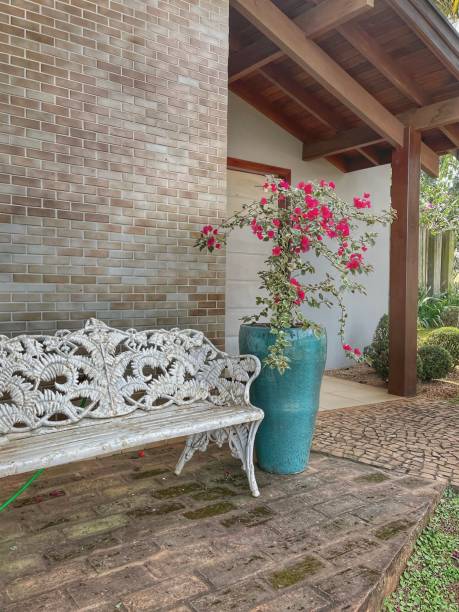 istock Home external decoration, white bench and flower vase 1616758148