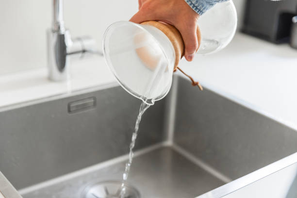 istock Young man preparing coffee using pour over coffee maker and drip kettle in the kitchen - Morning Routine before work 1616768695