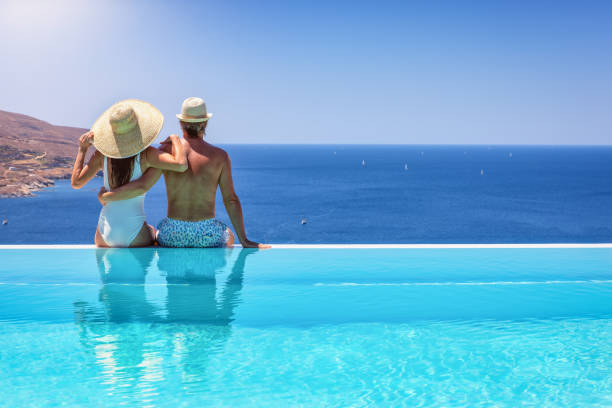 istock A couple hugging at the edge of an infinity pool 1616769608