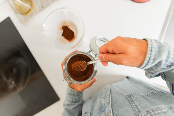 istock Young man preparing coffee using pour over coffee maker and drip kettle in the kitchen - Morning Routine before work 1616770832