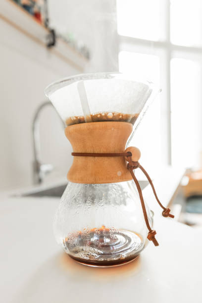 istock Young man preparing coffee using pour over coffee maker and drip kettle in the kitchen - Morning Routine before work 1616771699