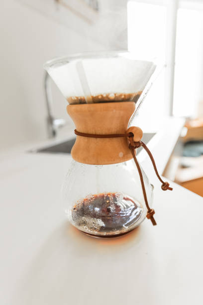 istock Young man preparing coffee using pour over coffee maker and drip kettle in the kitchen - Morning Routine before work 1616771855
