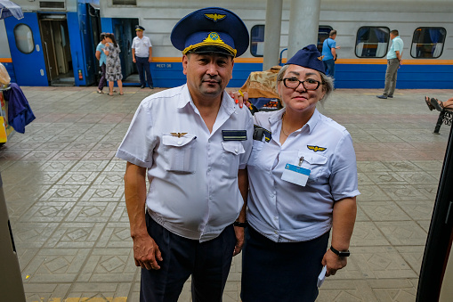 Zhetygen, Kazakhstan - August 8, 2023: Train inspectors at the Zhetygen railway station in Kazakhstan.