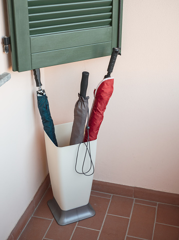 three dry umbrellas in a basket