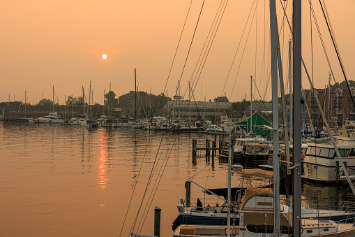 Canadian wildfires smog aftermath. Boats and yachts in moored in the harbor on the water bay of Severn River, Annapolis, Maryland