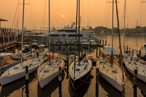 Canadian wildfires smog aftermath. Boats and yachts in moored in the harbor on the water bay of Severn River, Annapolis, MD
