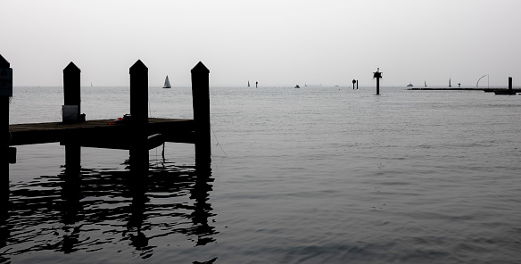 Smog after Canadian wildfires above the pier of Annapolis Bay and wooden jetty above Severn River in Annapolis, Maryland