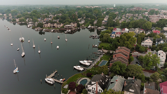 Spa Creek Marina and waterfront neighborhoods on Chesapeake Bay and Severn River under the smoggy sky after Canadian wildfires. Annapolis, Maryland aerial view