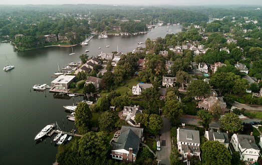 Riverside neighborhood under the smog: hazy neighborhood and waterfront on Chesapeake Bay in Annapolis, Maryland. Canadian fires aftermath. Aerial view