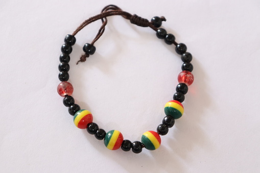 A Jamaican or African Rasta Charm bracelet with beads on an isolated White background