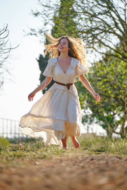 istock Optimistic female walking in garden 1616837178