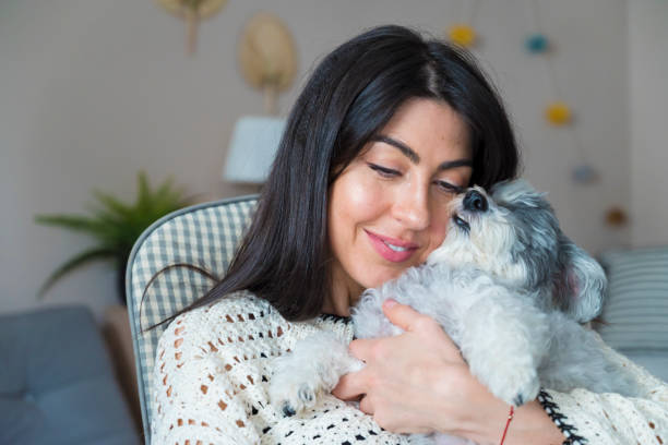 istock Woman Hugging her Havanese  Dog at home 1616849983