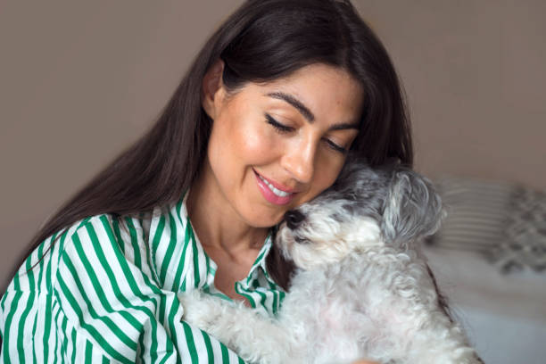 istock Woman Hugging her Havanese  Dog at home 1616851634