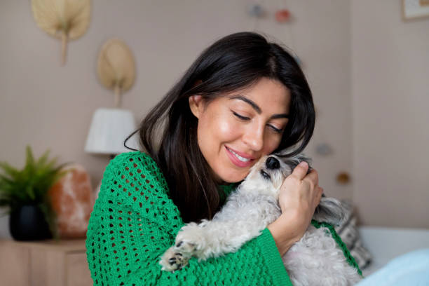 istock Woman Hugging her Havanese  Dog at home 1616852171
