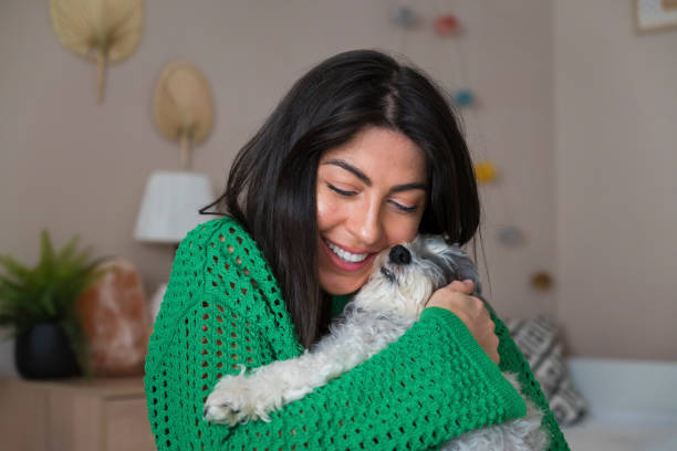 istock Woman Hugging her Havanese  Dog at home 1616852176