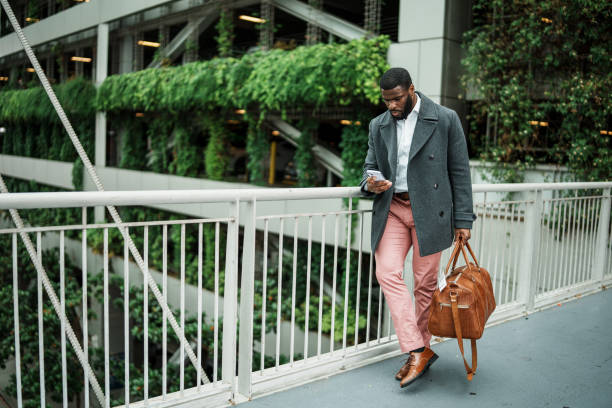 istock Businessman using smart phone while on business trip commute 1616871889