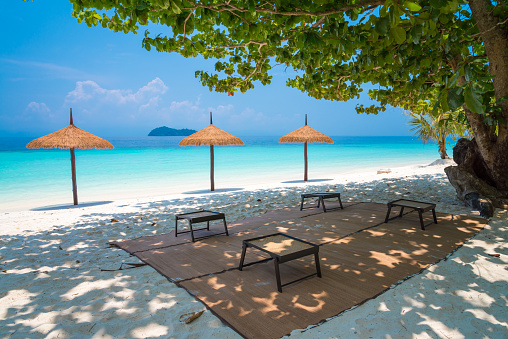 Beautiful tropical island white sand beach Andaman sea in blue sky sunny day. Summer beach holiday, seascape concept.