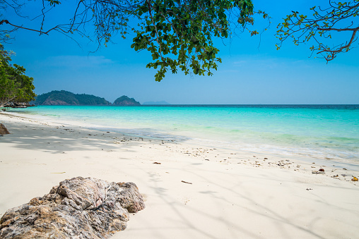 Beautiful tropical island white sand beach Andaman sea in blue sky sunny day. Summer beach holiday, seascape concept.