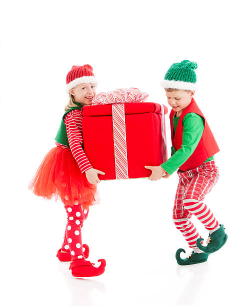 istock Two Christmas Elves Carry a Big Heavy Wrapped Present 161689089