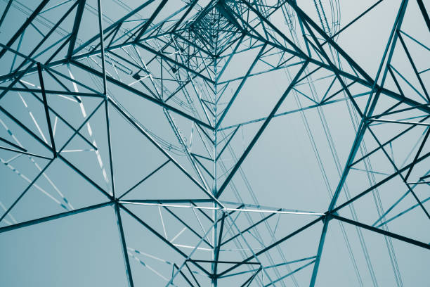 istock Abstract pattern from bottom view of high voltage pole power electricity transmission tower post. 1616891727