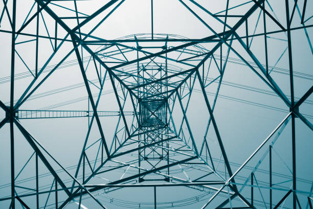 istock Abstract pattern from bottom view of high voltage pole power electricity transmission tower post. 1616891744