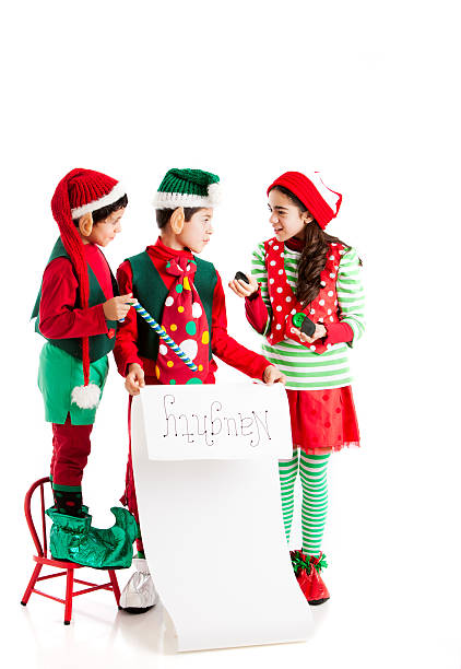 istock Christmas Elves Study Santas Naughty List with Coal 161690565