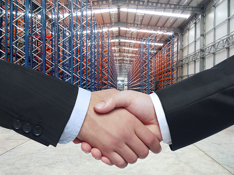 Handshake inside of a warehouse in a factory building
