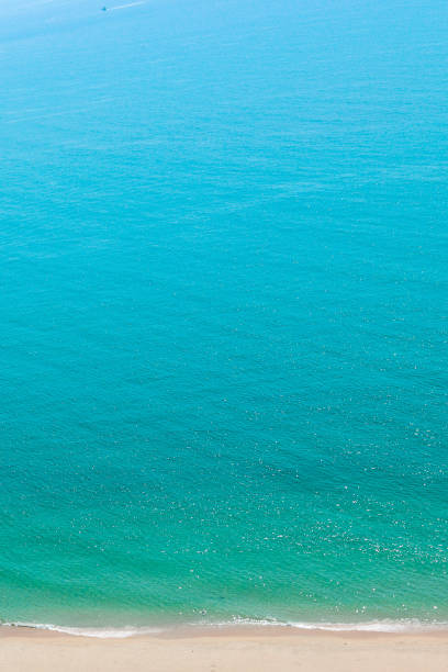 Vertical image.\nOcean Back ground.\nAerial view of pacific ocean and beach