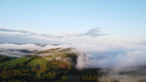 istock Ethereal Sunrise: Aerial Drone Footage of Sunlight Piercing Through Valley Mist 1616914154
