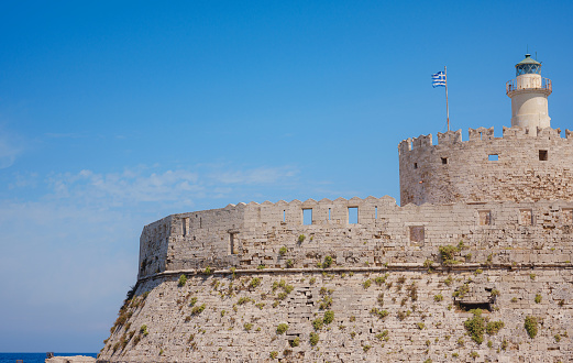 Mandraki port and fort of St. Nicholas. Rhodes, Greece. Hirschkuh statue in the place of the Colossus of Rhodes, Rhodes, Greece travel in summer sunny day