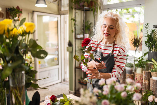 istock Curly-Haired Worker in the Floral Wonderland 1616940118