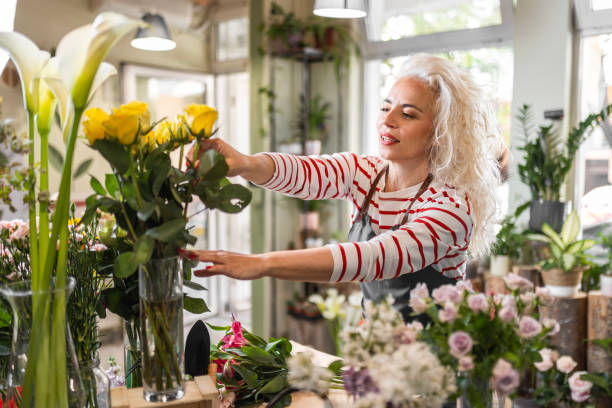 istock Curly-Haired Woman Tending Flowers 1616941195