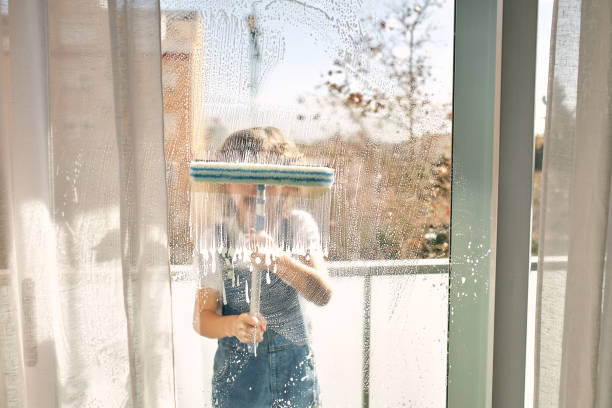 istock Unrecognizable boy washing windows at home 1616945277
