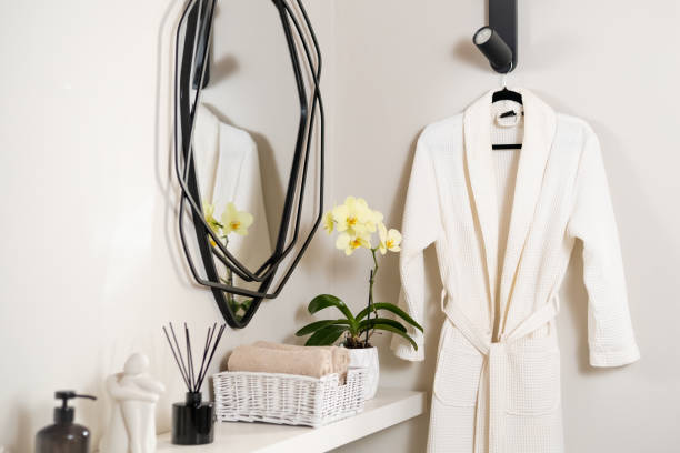 istock Bathrobe hanging on a hanger in a spa salon near a table with decor 1616951151