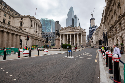 London, England, UK - August 14, 2023: London Financial district on a rainy day in August 2023. In the background is the Royal Exchange and on the left The Bank of England. The statue is of Wellington. London, England, UK.