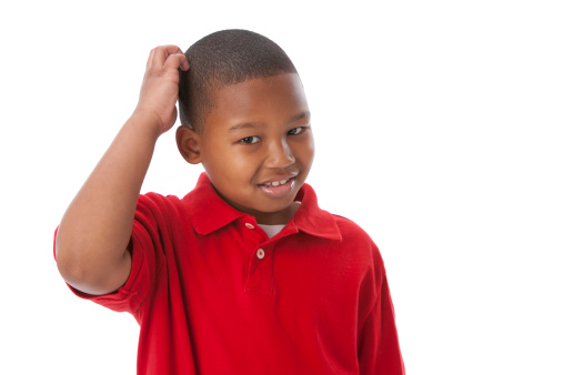 A head and shoulders image of an 8 year old African American little real boy scratching his head as if he is thinking or confused.   For similar images, please click on the lightboxes below: