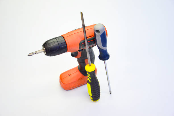 Electric screwdriver and hand screwdriver set on white background