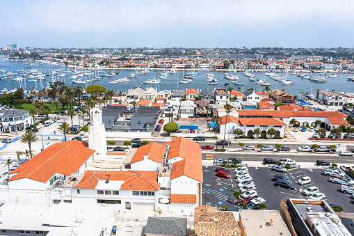 Newport Beach, CA USA - September 8, 2019: Balboa boardwalk and Balboa Island area of Newport Beach with a view from the auto ferry as it approaches the dock near the Ferris wheel.