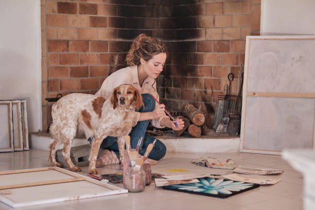 istock Young woman with dog drawing 1616980691