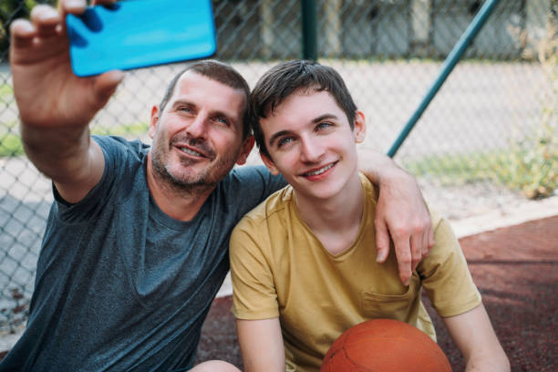 istock Morning Training. Father And Son Playing Basketball. Conversation between father and a son 1616985705