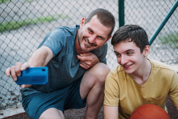 istock Morning Training. Father And Son Playing Basketball. Conversation between father and a son 1616986012
